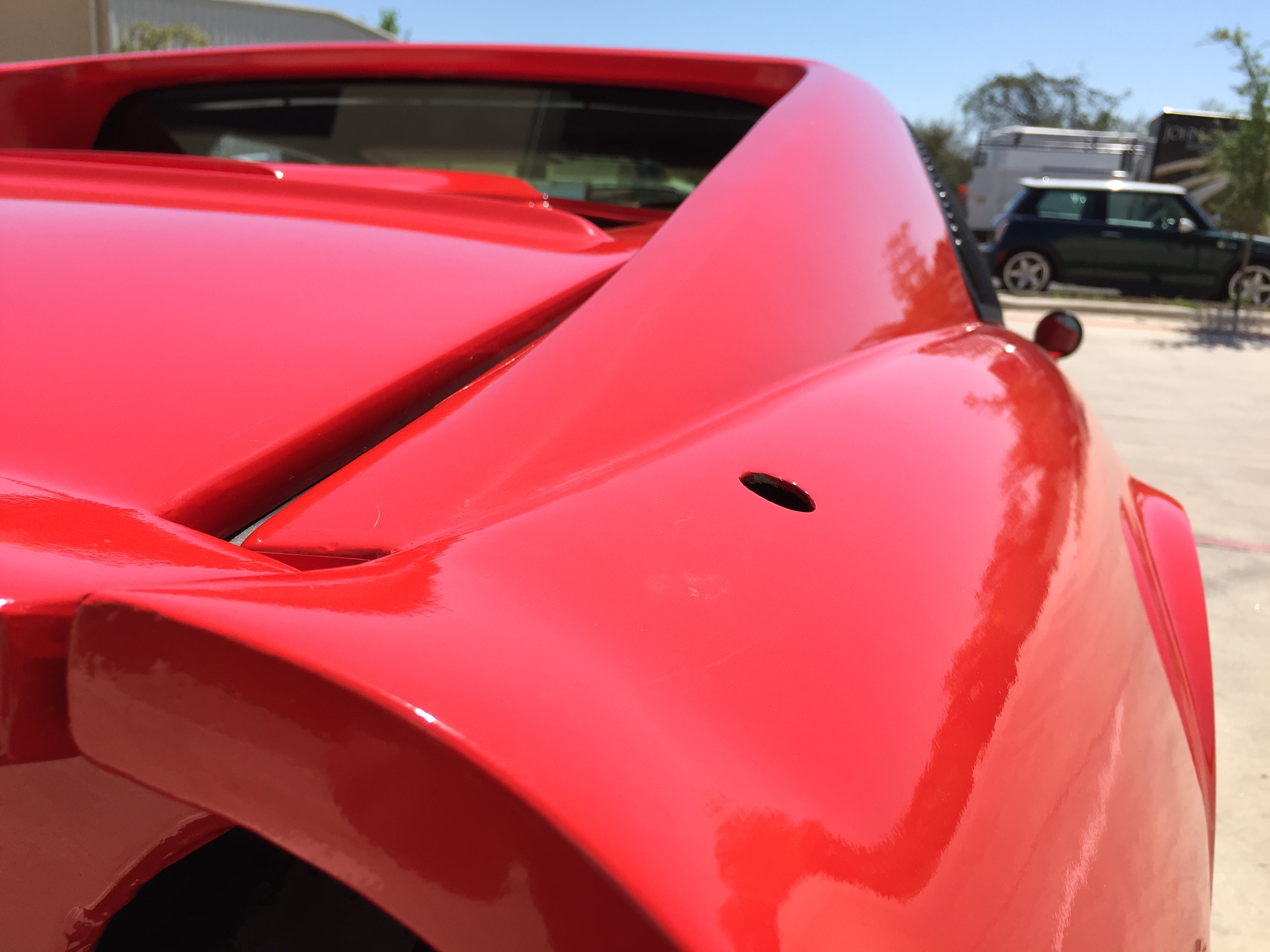 Ferrari kit car wrapped in gloss hotrod red detail photo from passenger rear angle.