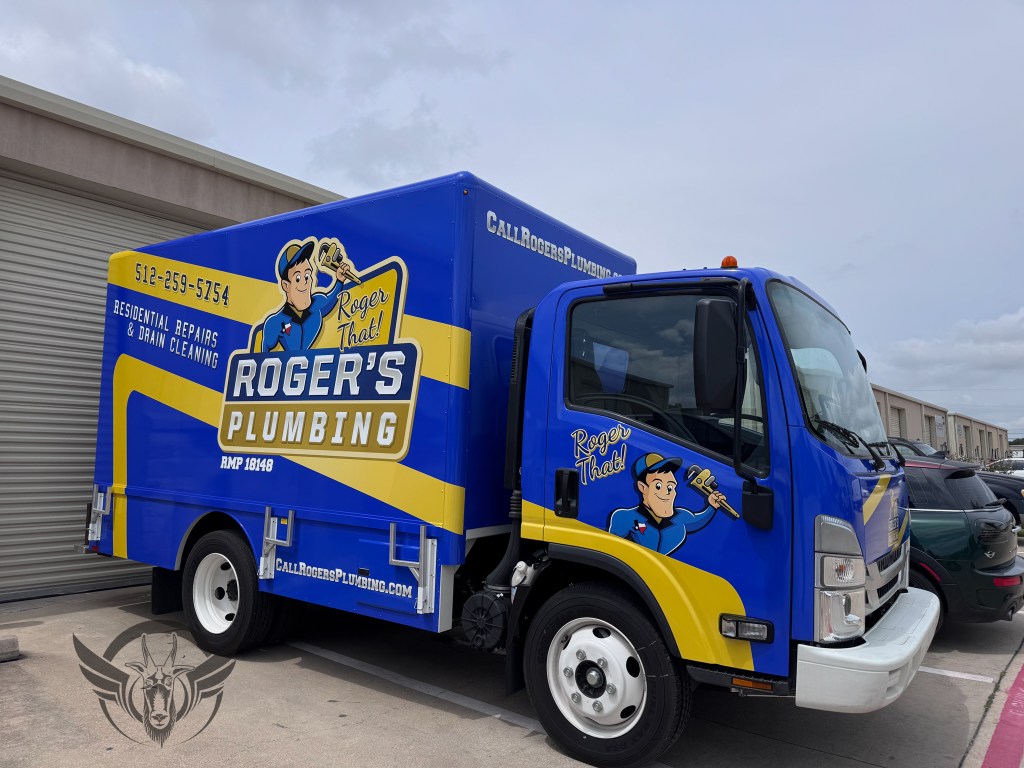Large Box truck wrapped with a printed wrap displaying Roger's Plumbing company.  Bright blue with a large yellow stripe and logo on the sides. 