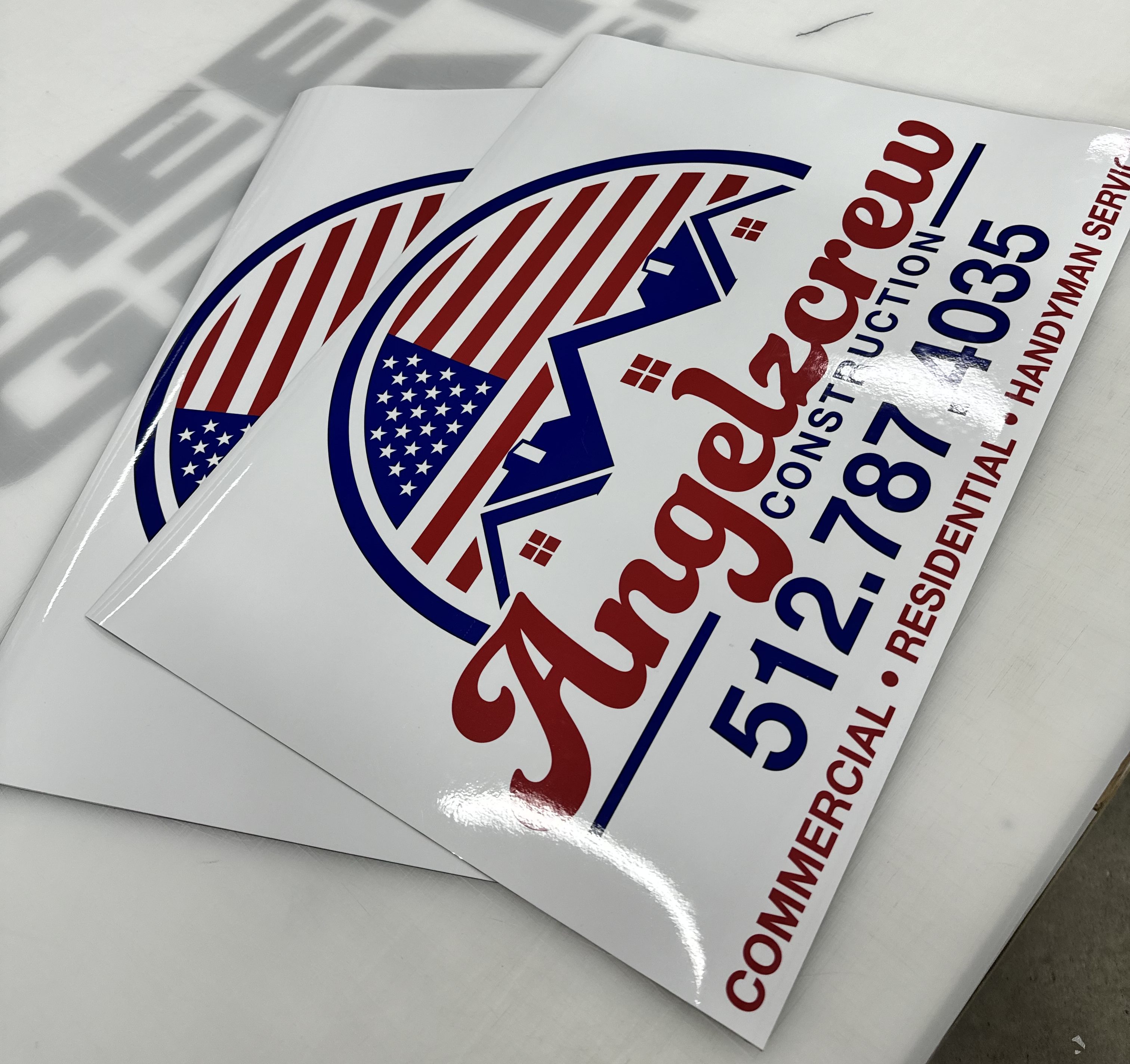 A set of printed vehicle magnets sitting on a table.  